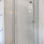 Shower with glass enclosure and hook on door