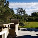 Terrace with seating area and view of green garden