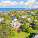 Village with thatched houses and view of the sea