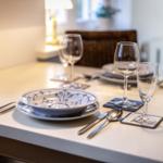 Table set with plates, bowl, glasses, and cutlery.
