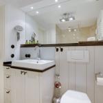 Bathroom with sink, mirror, and toilet.