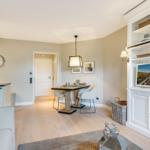Living and dining area with dining table, sofa, and built-in TV cabinet.