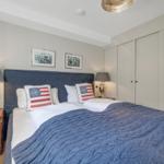 Schlafzimmer mit Bett, Nachttischen und Kleiderschrank.