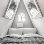 Bedroom with sloped ceilings, three windows, and white bed.