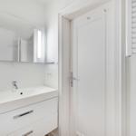 Bathroom with sink, mirror, and heater
