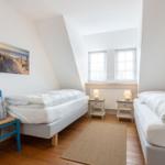 Zwei Betten, Fenster, Nachttische, Wandbild, Holzboden, Tür