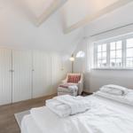 Bedroom with bed, closet, and window