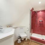 Bathroom with shower, sink, and toilet