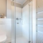Bathroom with shower, toilet, and heater