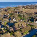Village with thatched roofs by the sea