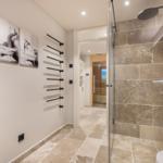 Bad mit Dusche, Steinfliesen und Wandbildern