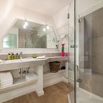 Bathroom with shower, sink, and towels