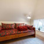 Bedroom with daybed, window and standing lamp