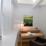 Schreibtisch mit Stuhl und Bild an der Wand