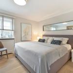 Bedroom with bed, nightstand, chair, and window