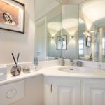 Bathroom with sink, mirror, and decorative items