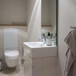 Bathroom with toilet, sink, and towel rack