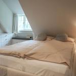 Bedroom with double bed, nightstand, and window