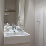 Bathroom with sink, mirror, and toilet
