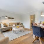 Living and dining area with sofa, table, and chairs.