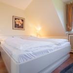 Bedroom with double bed, nightstand, and window