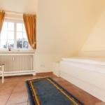 Bedroom with bed, chair, window, and rug