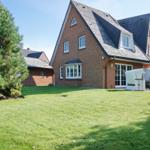 Red brick house with large garden and terrace with garden furniture.