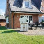 Red brick house with terrace, garden, and outdoor seating.