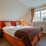 Bedroom with double bed, nightstands, and window.