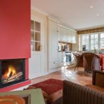 Kitchen with dining area and fireplace in living room