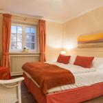 Bedroom with double bed, window, curtains, and TV.
