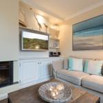 Living room with fireplace, sofa, and TV