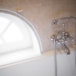 Bathtub with shower head and bathroom window