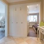 Entrance with wardrobe, view into bedroom and dining room.