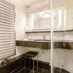 Bathroom with marble wall, sink and heater