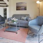 Living room with gray sofa, two chairs, and a coffee table.