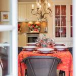Dining table with tablecloth and glasses in dining area