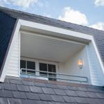 Attic window with balcony and outdoor lighting