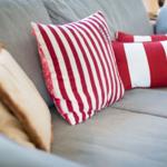 Gray sofa with red and white cushions