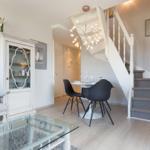Living and dining area with staircase and glass table