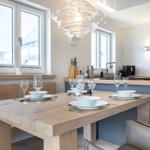 Wooden table with chairs and windows in dining area