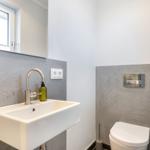 Bathroom with sink, mirror, and toilet