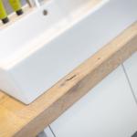 Sink on wooden surface with soap dispenser