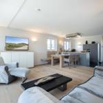 Living and dining area with fireplace, TV, and dining table.