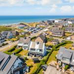Sea view of holiday homes with beach and parking lot
