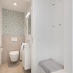 Bathroom with toilet, sink, and shower