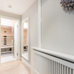 Sauna with wooden wall and mirror on the wall