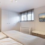 Bedroom with bed, wardrobe, and wall picture