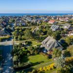 Village with traditional houses and view of the sea.