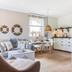 Living and kitchen area with sofa, dining table, and kitchen unit.